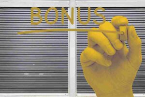 mano dorata scrive la parola bonus e sullo sfondo un garage chiuso